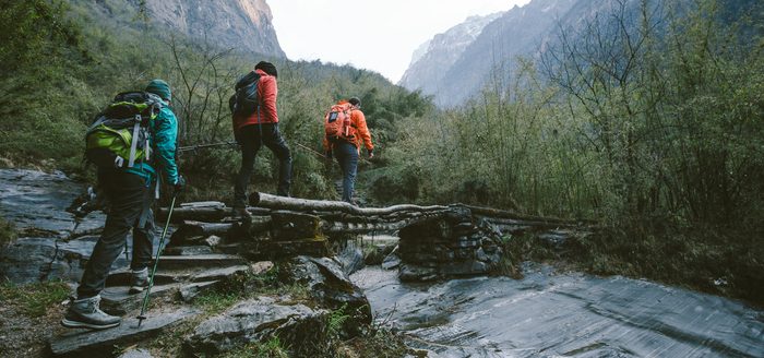 Group of trekkers cross the bridge at Annapurna region on Himalayas.