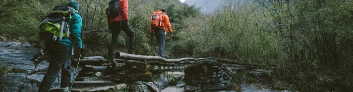 Group of trekkers cross the bridge at Annapurna region on Himalayas.